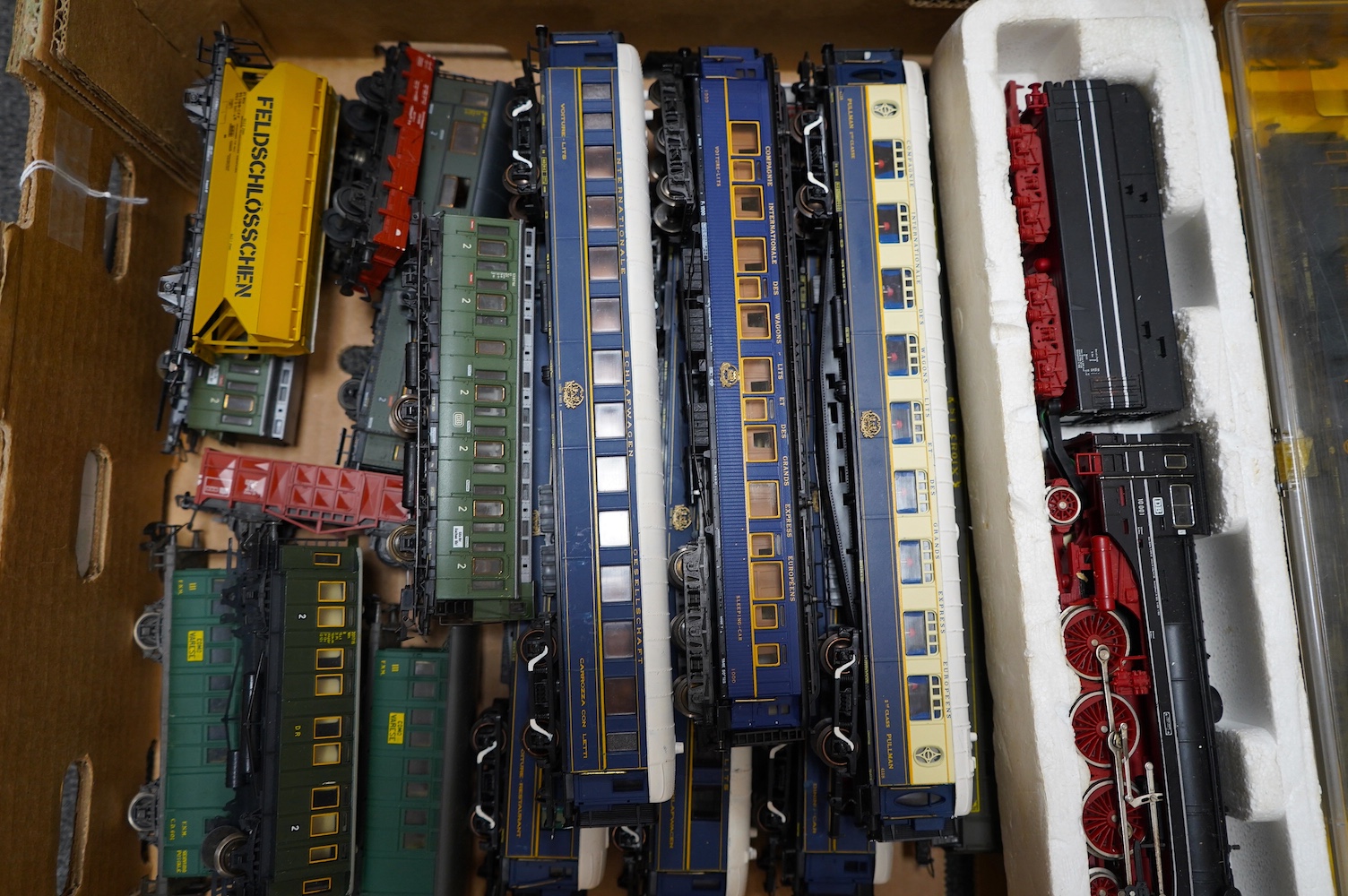 Twenty-four HO gauge model railway by Lima, Trix, Fleischmann, etc. including a German DB 4-6-2 tender locomotive, 10 001, fourteen Continental outline bogie coaches, 4-wheel coaches, and freight wagons. Condition - fair